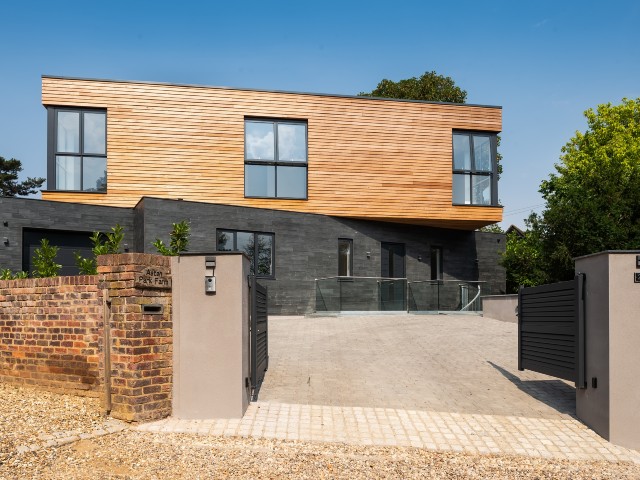 slate and timber-clad eco self-build with gated driveway