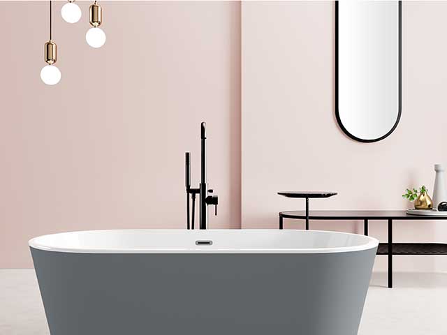 Affordable bathroom renovations: acrylic freestanding tub in grey with pale pink bathroom walls