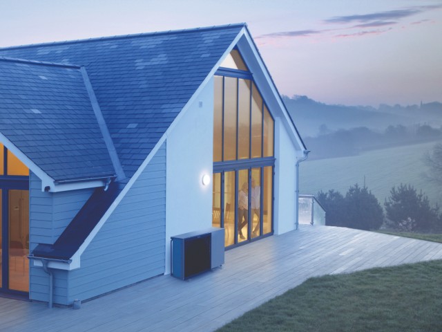 air source heat pump outside a modern home in a rural area