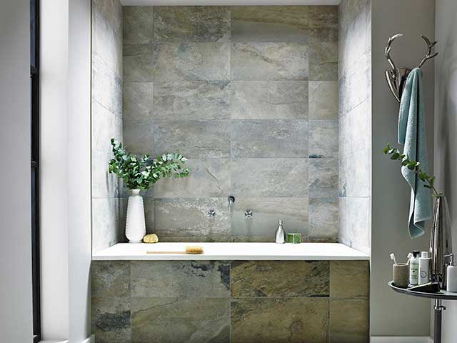 Slate effect porcelain tiles in bathroom renovation with built in bath