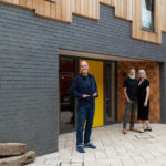 Olaf and Fritha from Grand Designs outside the triangle house with Kevin McCloud