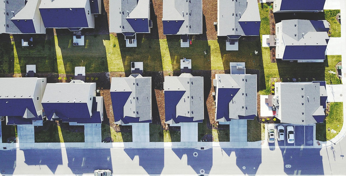 overhead shot of street full of houses with heat pumps