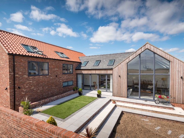 large areas of glazing in a modern extension with double-height ceilings