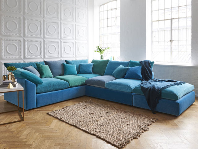 blue corner sofa in various shades from sky blue to green and teal with scatterback cushions and squishy seat pads