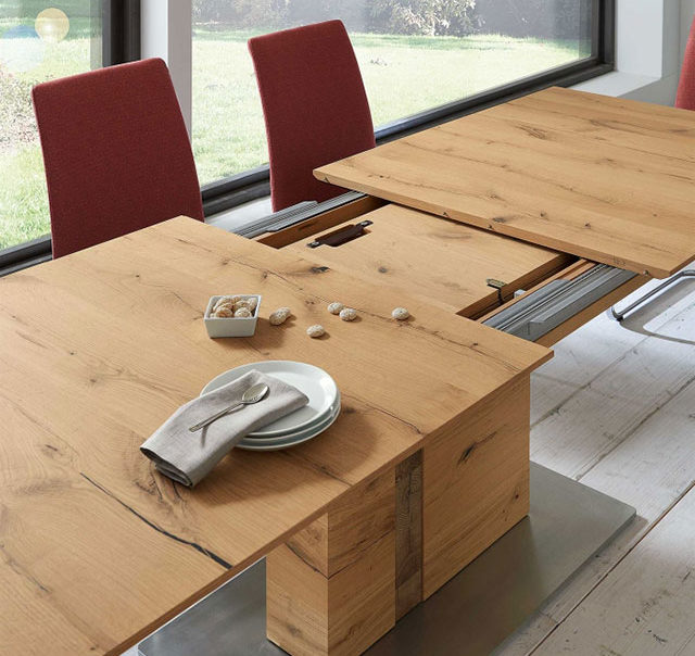 Felser oak extending dining table from Barker and Stonehouse with red fabric chairs