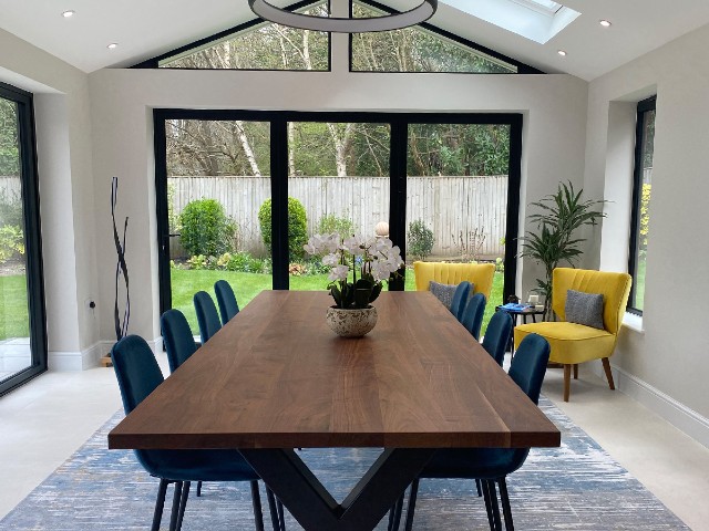 kitchen with garden view, oak dining table, blue chairs and mustard accent chairs