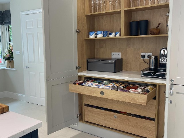 large kitchen with hidden oak storage cupboard for plates, glasses and coffee machine