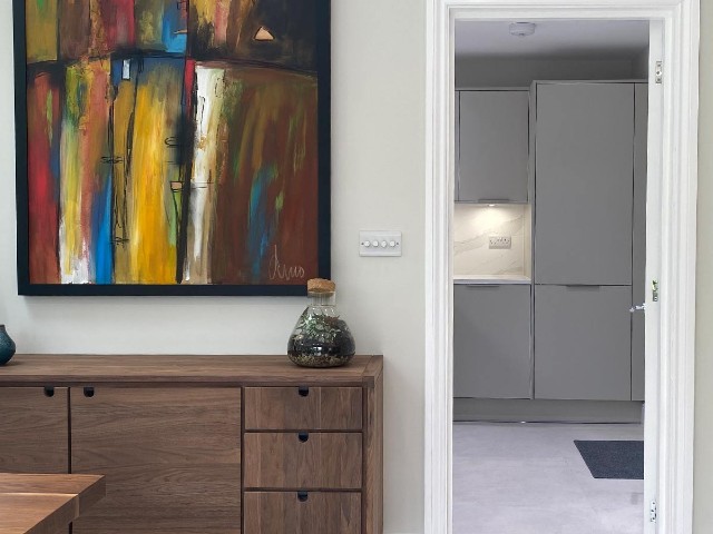 kitchen extension with large utility room, walnut sideboard and colourful artwork