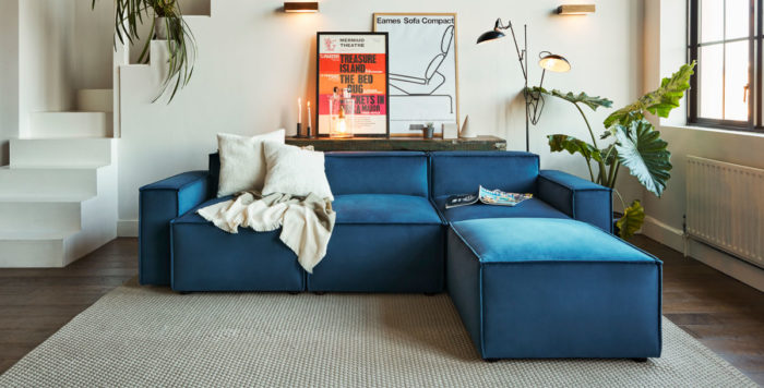 blue corner sofa in boxy style in a modern apartment