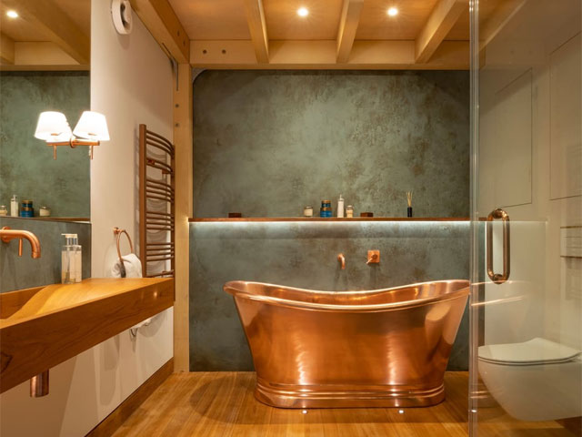Copper freestanding bath in luxury bathroom inside Boathouse Wood Awards winner