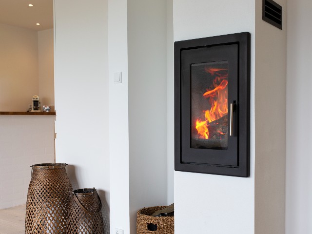 wood burning stove with in-built chimney integrated into the wall