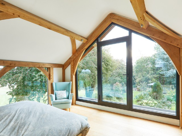 bespoke floor to ceiling windows in a room with pitched ceiling