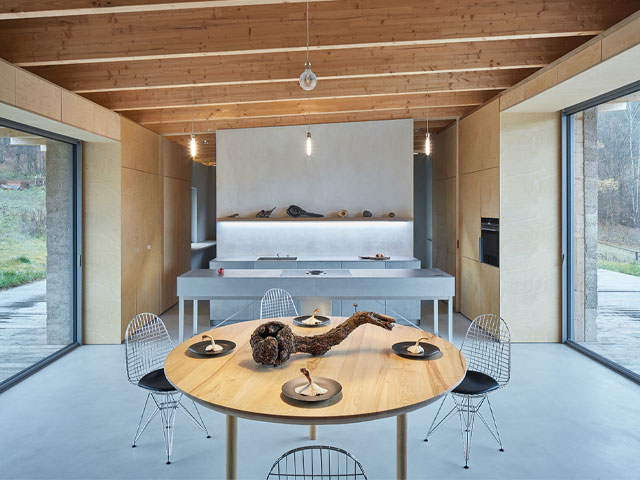 inside a timber-frame hempcrete house with large picture windows