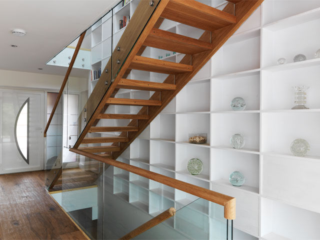 wooden staircase with glass balustrades in an accessible devon house 