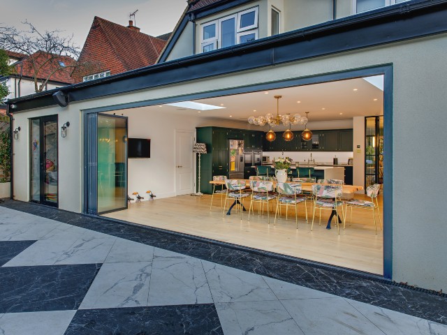 modern kitchen extension with fully opened glazing connecting indoors and out
