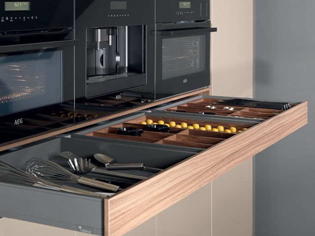 pull-out drawer under a bespoke coffee station in a modern hi-tech home