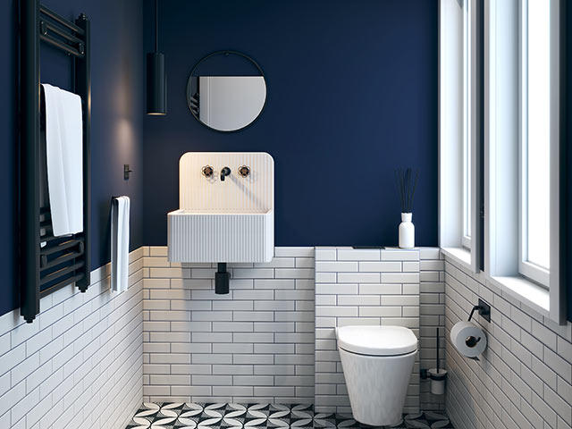 en-suite bathroom ideas: WC with white tiles, white sanitaryware, navy blue painted walls and black towel rail