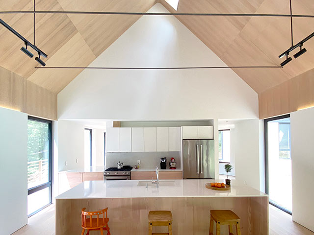 Inside of cork cladding home including kitchen with open plan breakfast bar