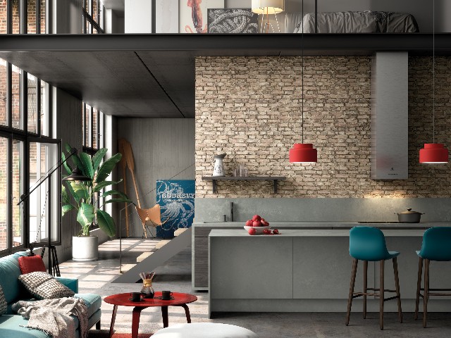 grey worksurfaces and splashback in industrial style open-plan kitchen with mezzanine bedroom 