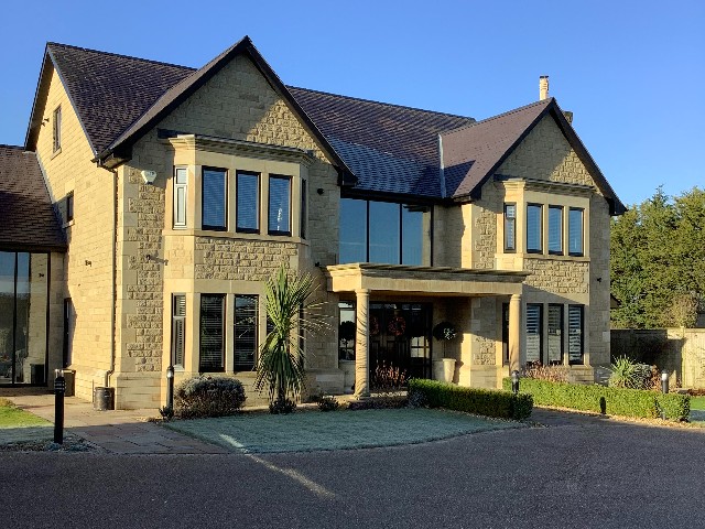 double-fronted self-build house in traditional stone 