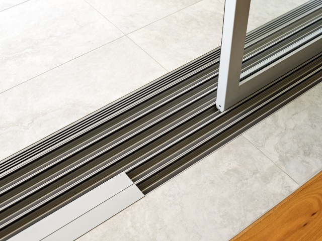 threshold drain fitted to sliding door connecting indoors and out
