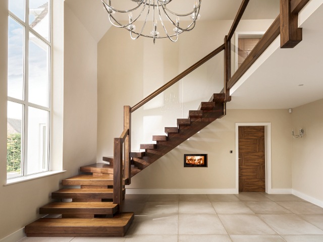 black walnut l-shaped staircase with wooden handrail and glass balustrade