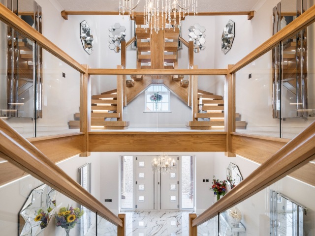 oak central staircase with oak treads and handrail and glass balustrade