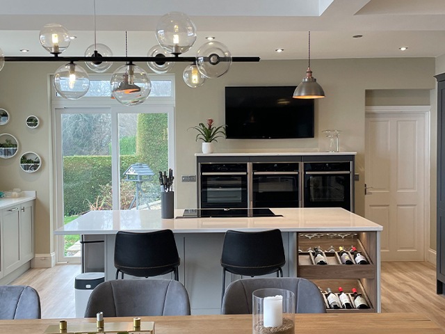 open-plan kitchen and diner with kitchen island and wine storage