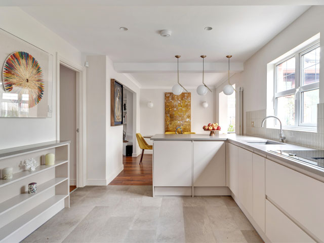 Spacious kitchen-diner in an 80s detached house created by removing walls between the kitchen, dining space and utility room