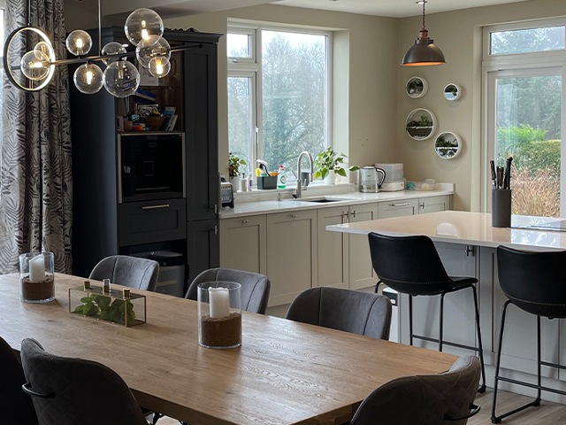 modern shaker kitchen with oak dining table and kitchen island with cooker