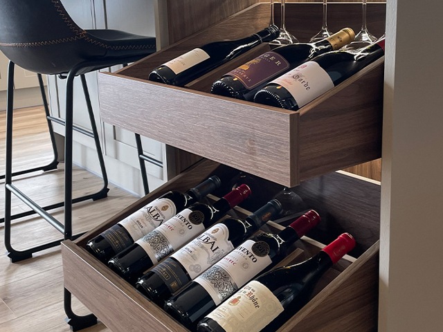 bespoke wooden wine cabinet with pull-out drawers that display the wine bottles 