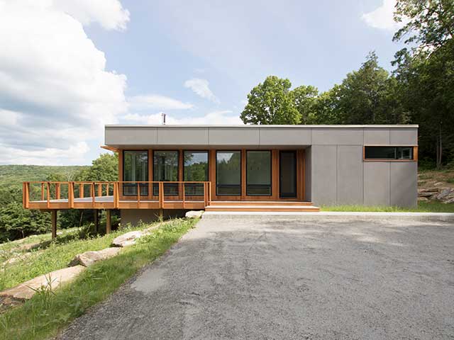 An insulated concrete foundation supports the four prefabricated modules of this home in Sharon, Connecticut, USA