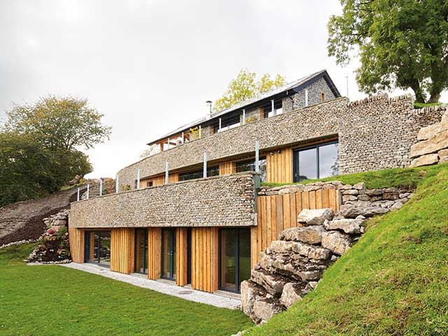 Earth Shelter home surrounded by earth on three sides nestled into a 45-degree slope