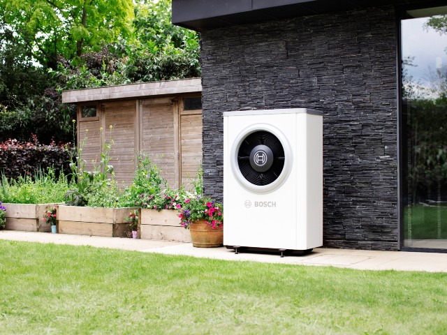 low maintenance energy efficient heat pump outside a modern house