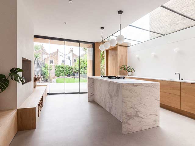 Period home extension of kitchen with bifold doors and marble worktop