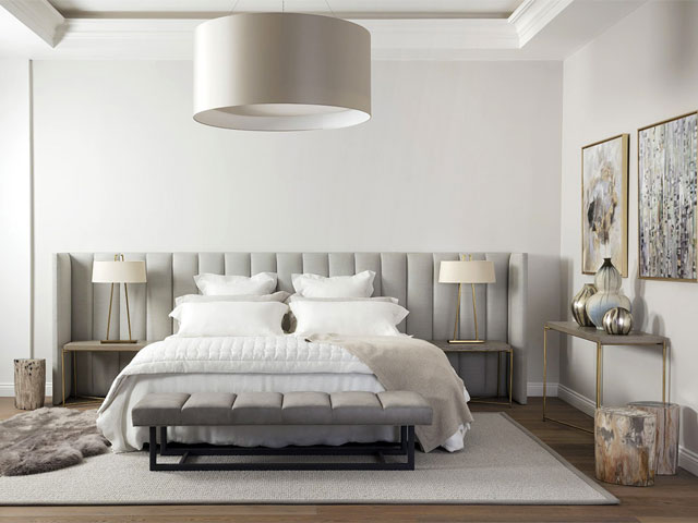 an oversized padded headboard is a great way to recreate the look of a hotel bedroom at home