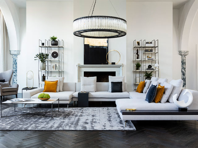 luxury white sofa with walnut dividers in a hotel-style living room with large chandelier