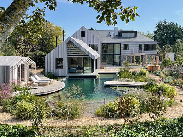 Grand designs house with natural swimming pond