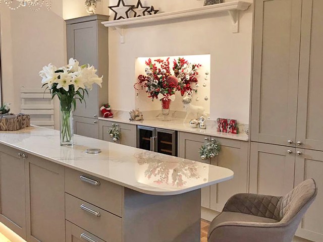 narrow space with grey storage cabinets, gloss worktops, wine fridge and Christmas decorations