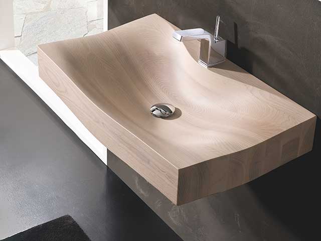 Wooden shallow-dip sink with chrome tap and dark walls