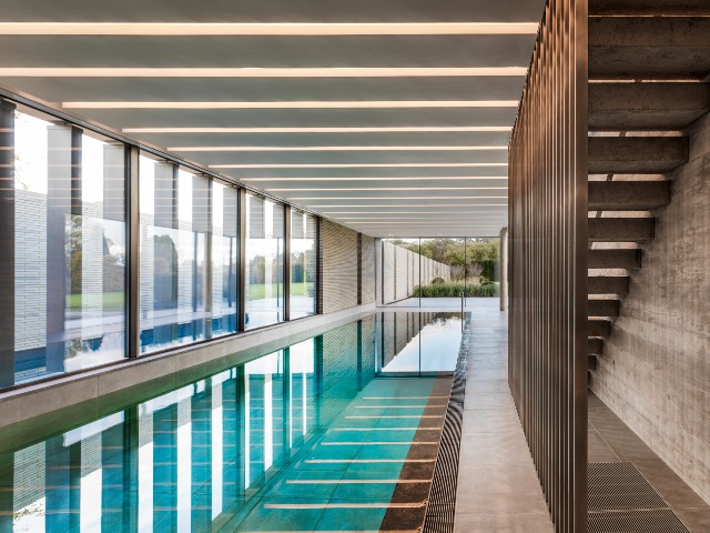 luxury swimming pool design with floor-to-ceiling windows bringing in lots of daylight