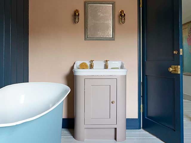 Colourful eco bathrooms scheme with freestanding bath and basin