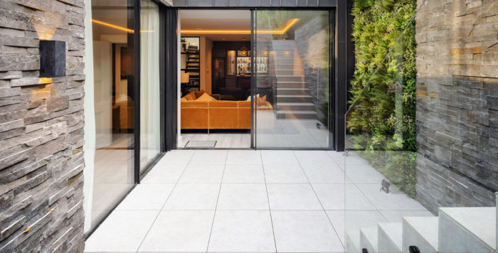 outdoor flooring ideas: large white floor tiles running from indoors to out