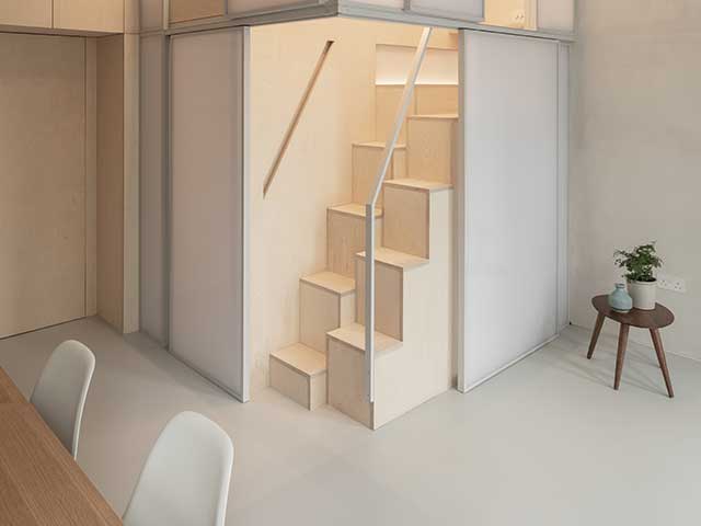 alternate tread staircase up to a raised bedroom in a tiny apartment in london