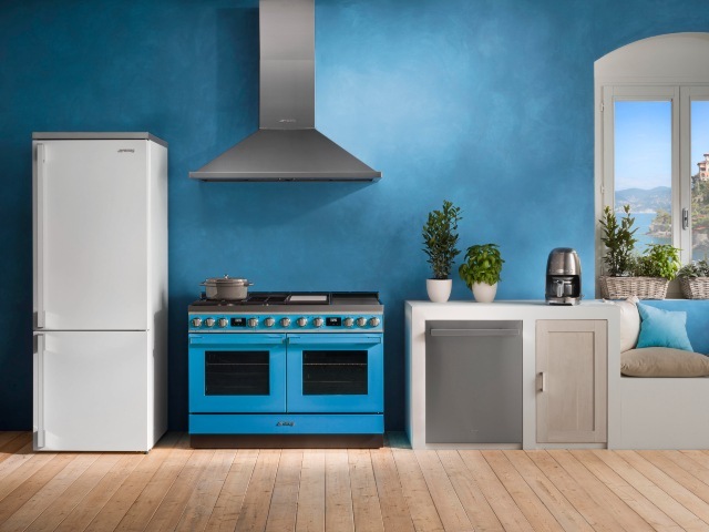 blue range cooker in blue kitchen with large exposed extractor fan
