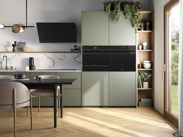 hi-tech oven, hob and extractor fan in modern kitchen with sage green cabinets