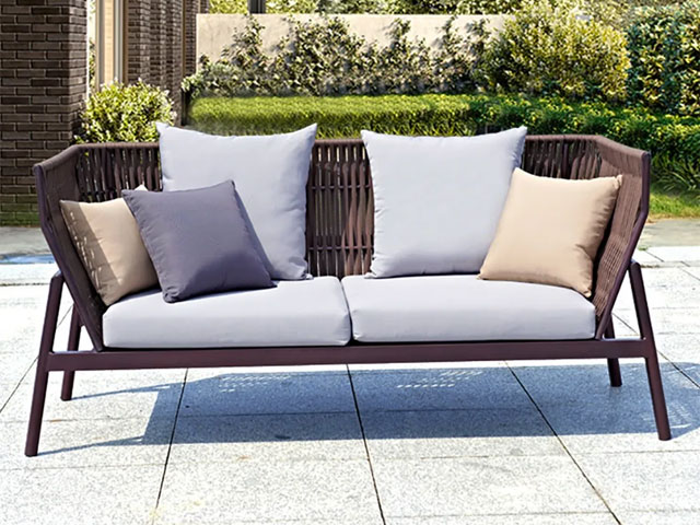 two-seater outdoor sofa with brown rattan and grey cushions