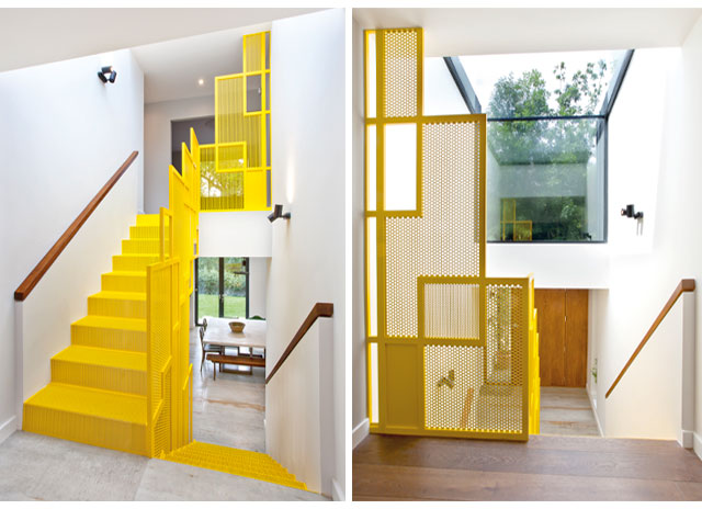 Yellow metal staircase in a contemporary new extension with large glazed ceiling
