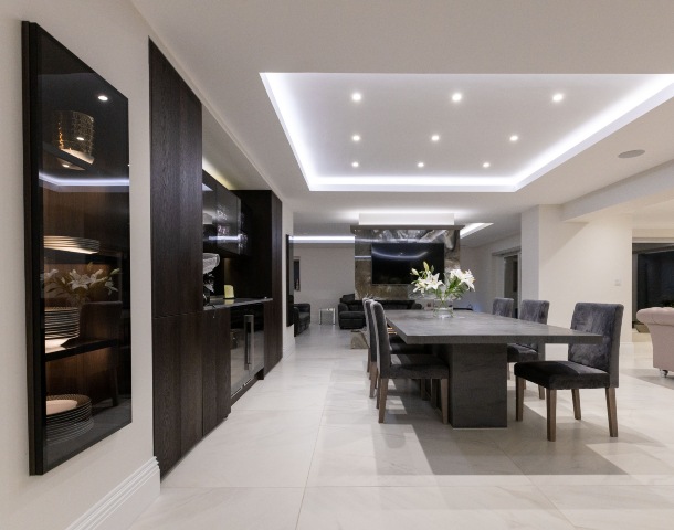 luxury dining room with bespoke cabinets, recessed lighting and open-plan living-dining area