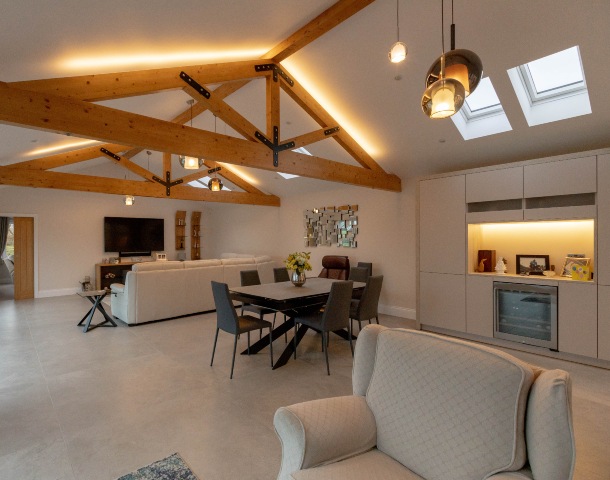 barn conversion with open plan living-kitchen-dining space and concrete-effect floor tiles